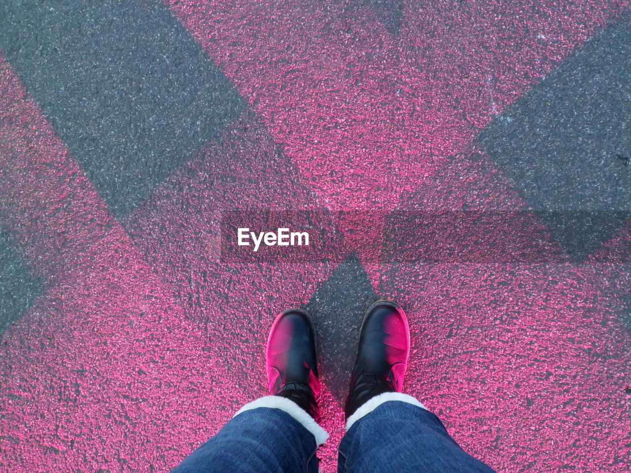 Low section of person standing on glowing street