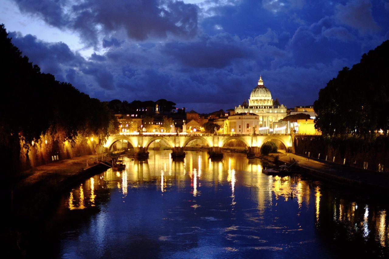 REFLECTION OF ILLUMINATED BUILDING IN WATER