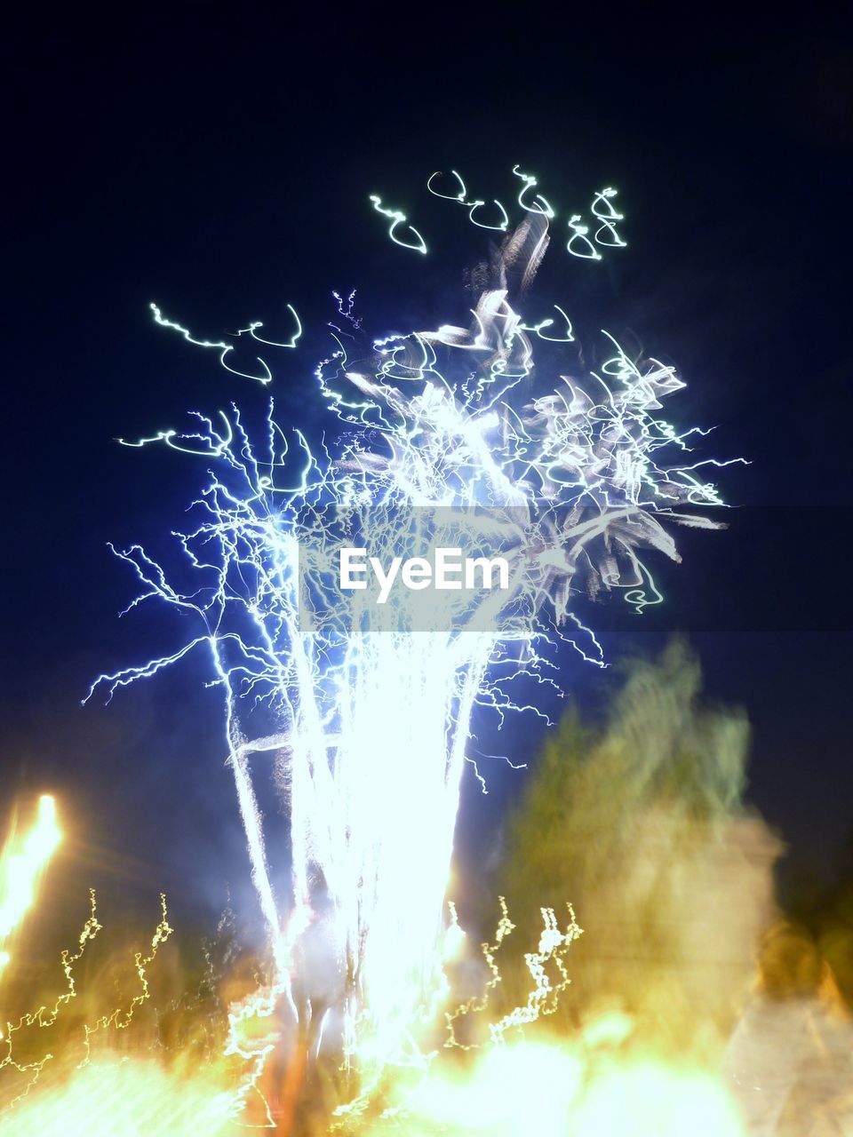 LOW ANGLE VIEW OF FIREWORKS DISPLAY