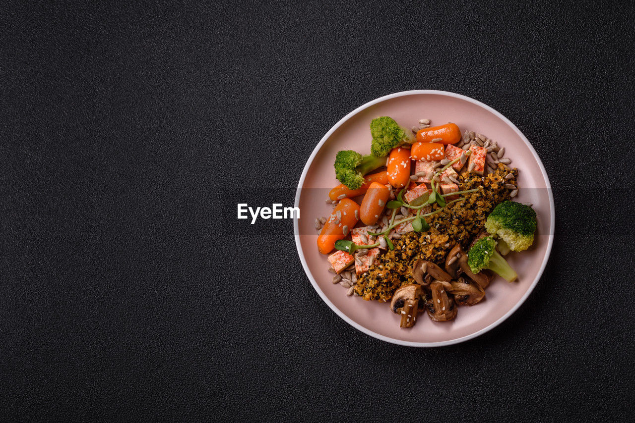 food and drink, food, healthy eating, wellbeing, studio shot, black background, freshness, vegetable, indoors, produce, plate, no people, copy space, meal, high angle view, still life, directly above, bowl, gray, herb, gray background, dish, asian food, vegetarian food