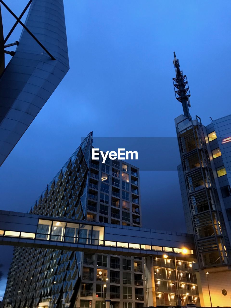 Low angle view of modern buildings against clear blue sky