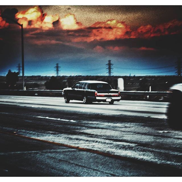 VIEW OF ROAD AGAINST CLOUDY SKY