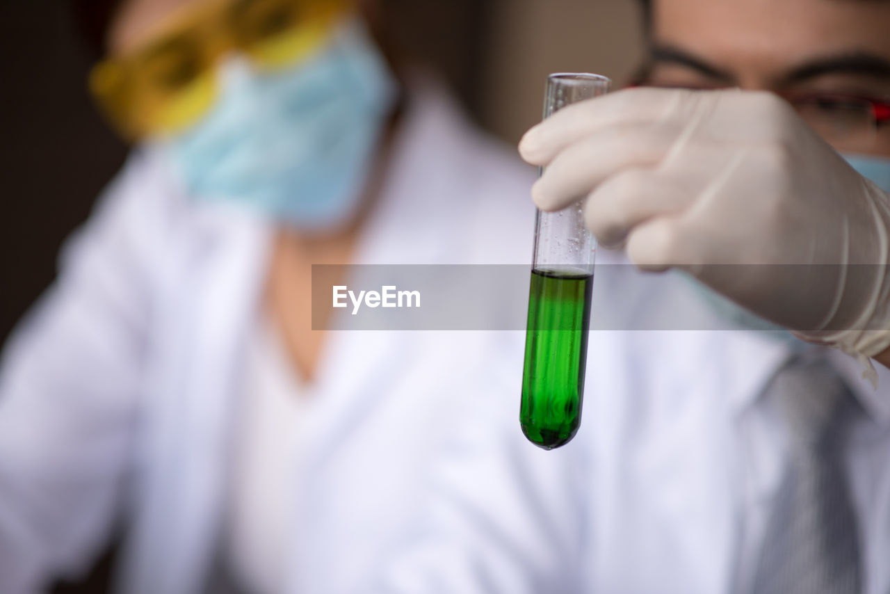 Man and woman performing experiment in laboratory