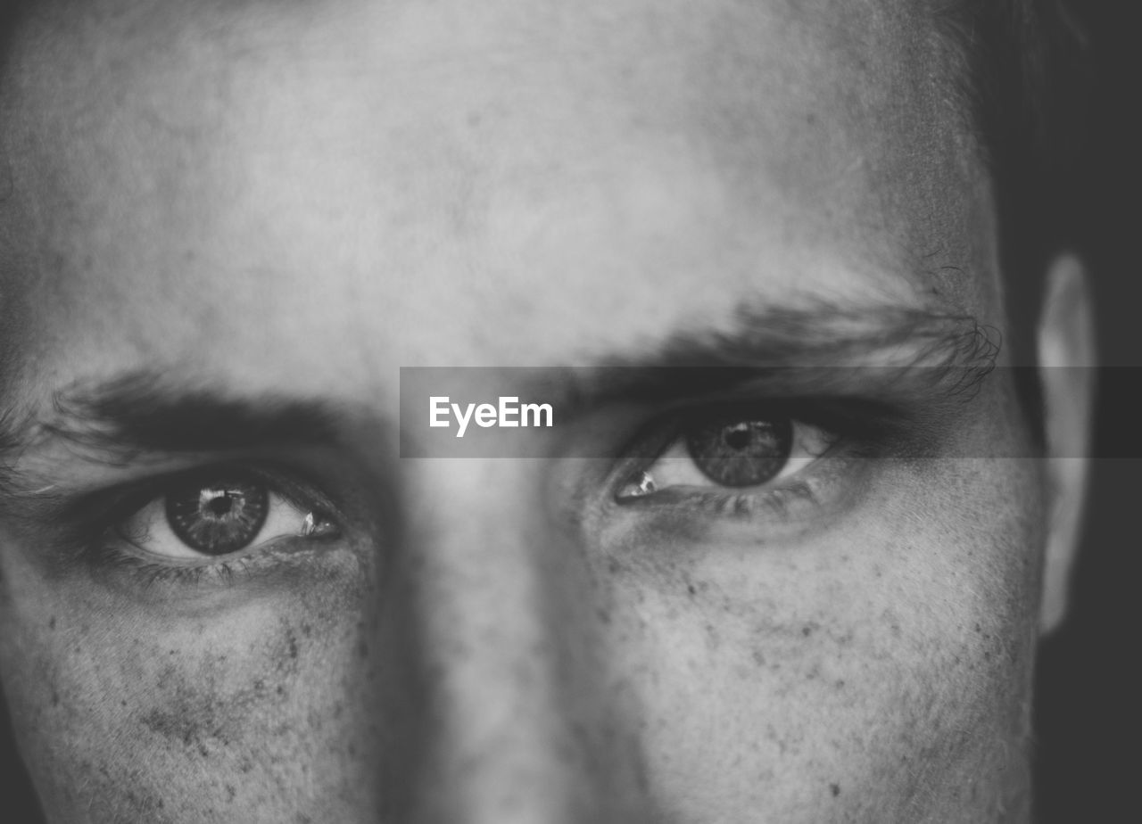 CLOSE-UP PORTRAIT OF YOUNG MAN WITH EYES