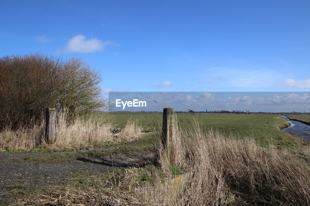 Scenic view of landscape against cloudy sky