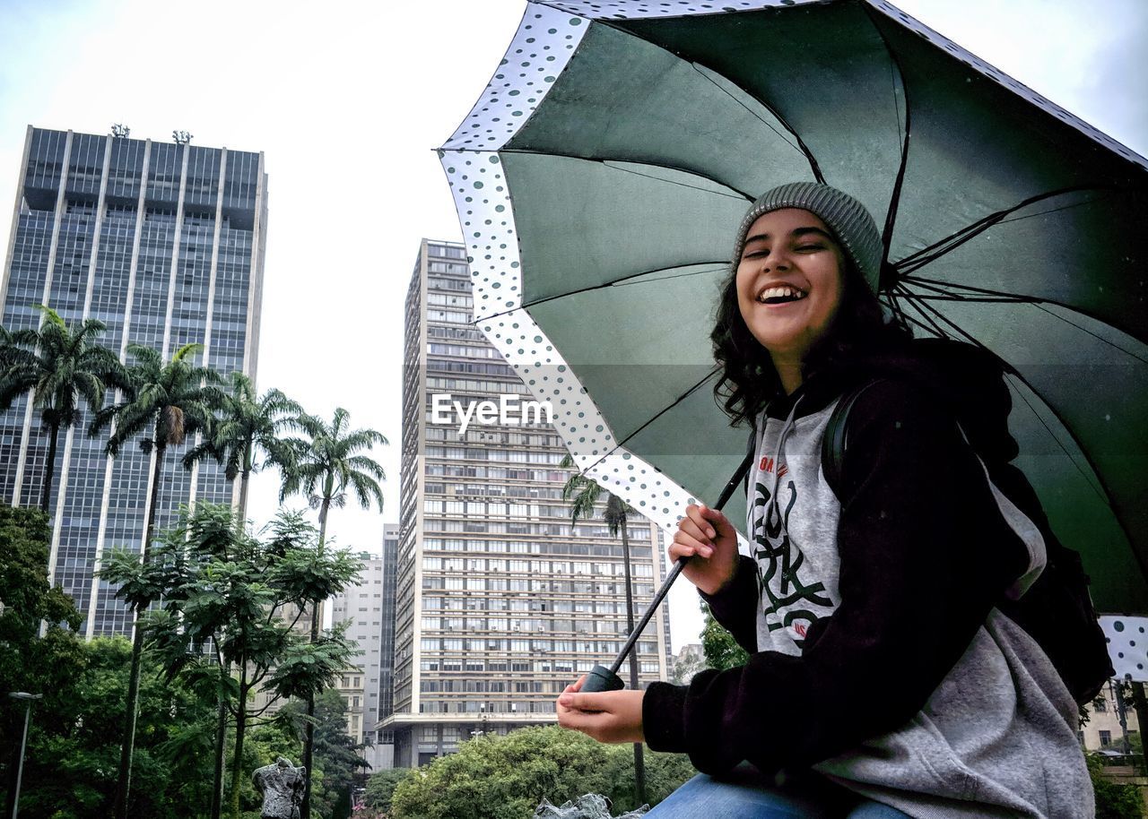 Portrait of smiling young woman standing outdoors