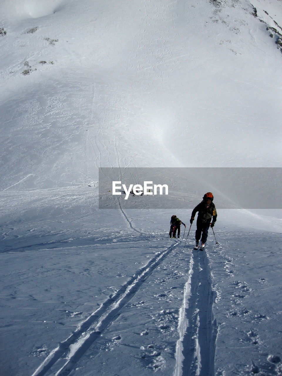 People skiing on snowcapped mountain during winter