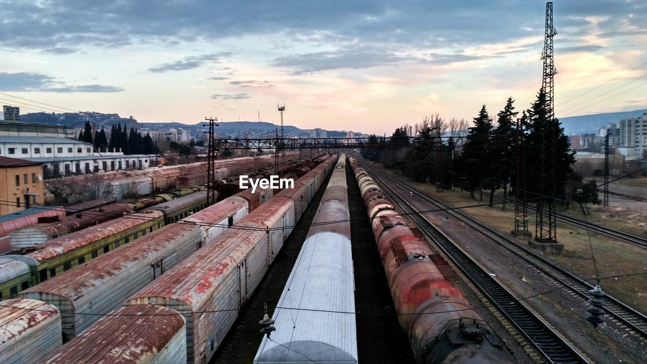 RAILROAD TRACKS AGAINST SKY DURING SUNSET