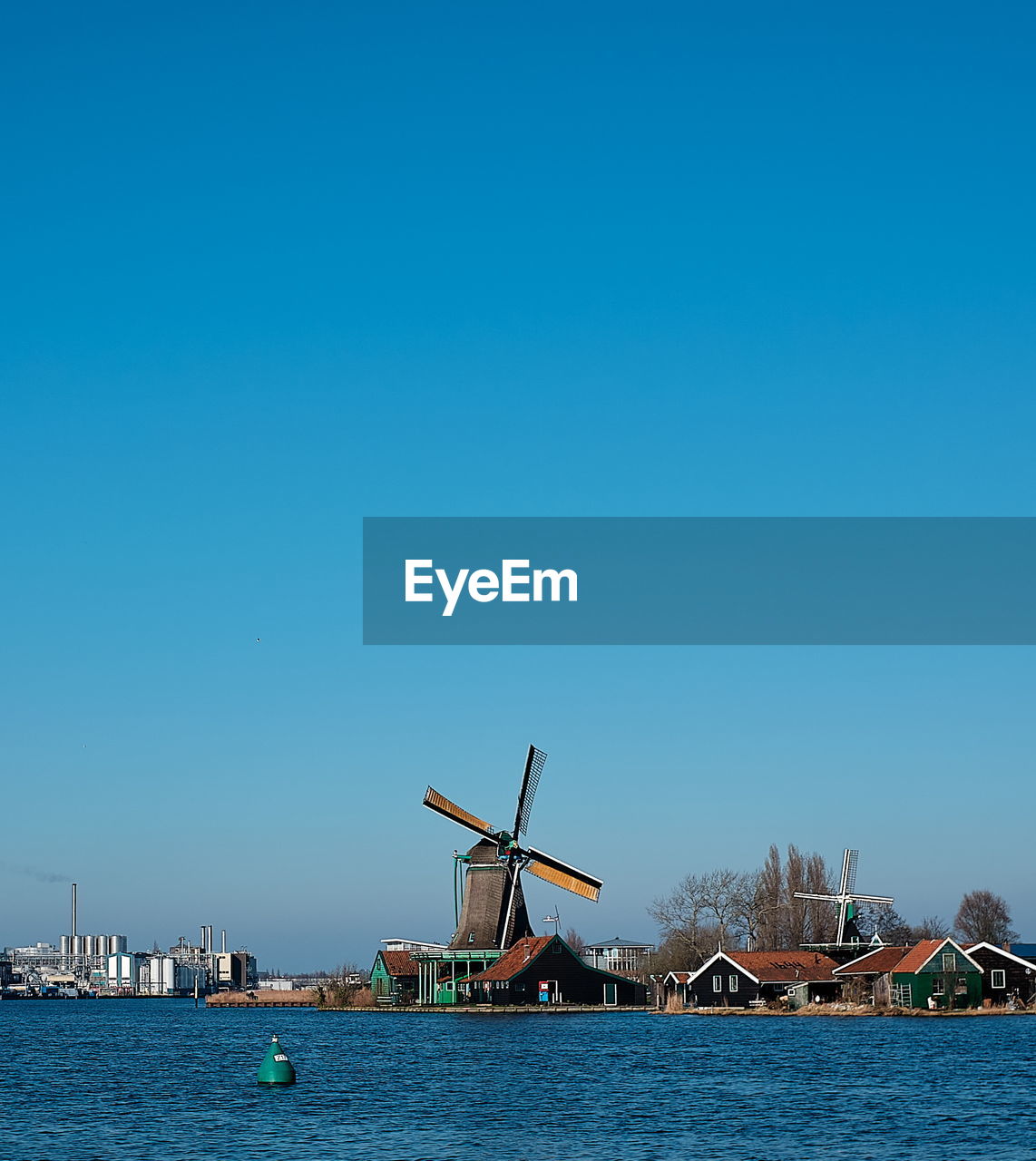 Windmill against clear blue sky