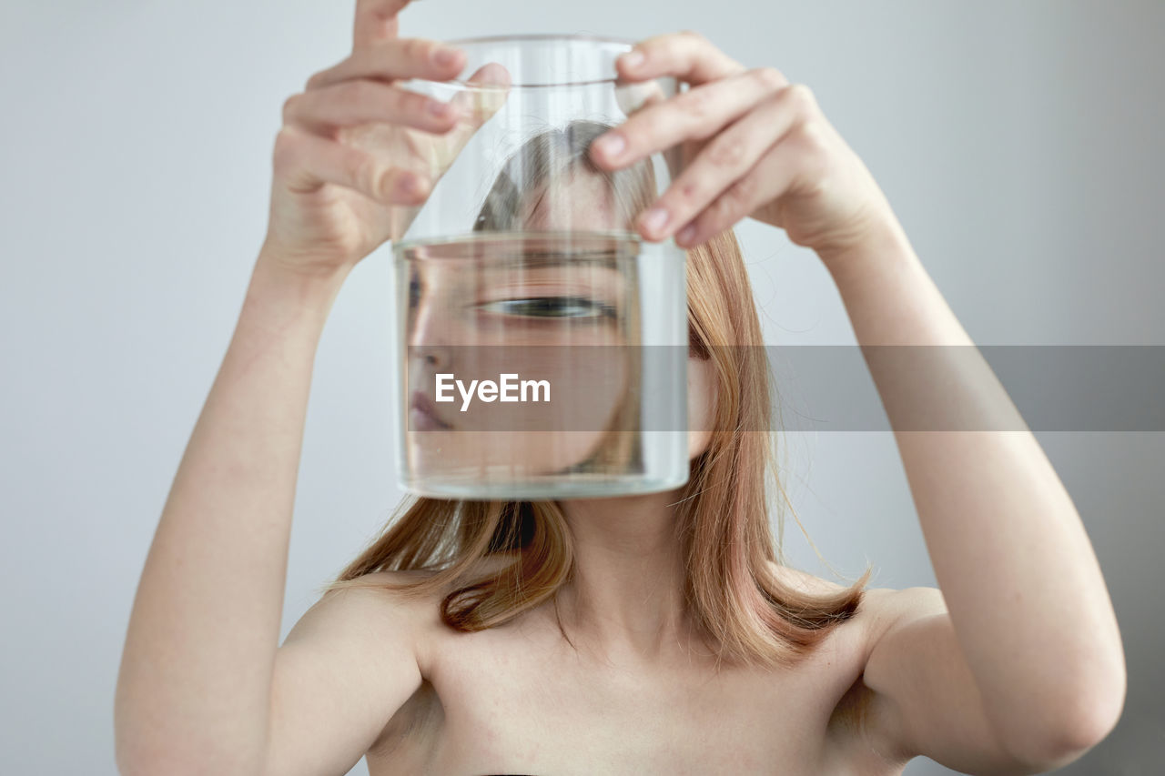 Midsection of woman drinking glass