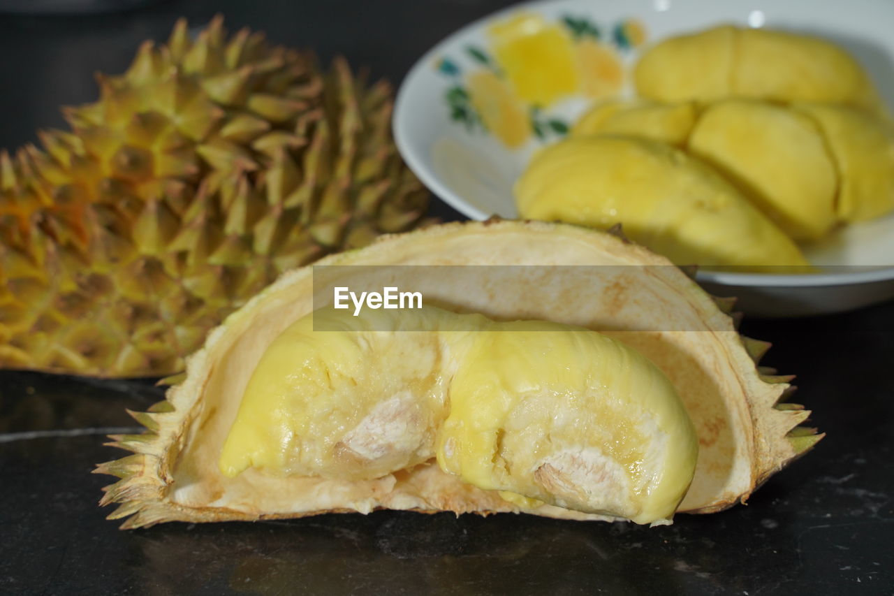 food and drink, food, freshness, healthy eating, plant, fruit, durian, produce, wellbeing, indoors, dish, pineapple, no people, tropical fruit, close-up, plate, slice, still life, asian food, yellow, ananas