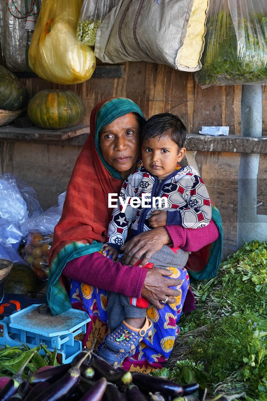 FULL LENGTH PORTRAIT OF MOTHER AND SON