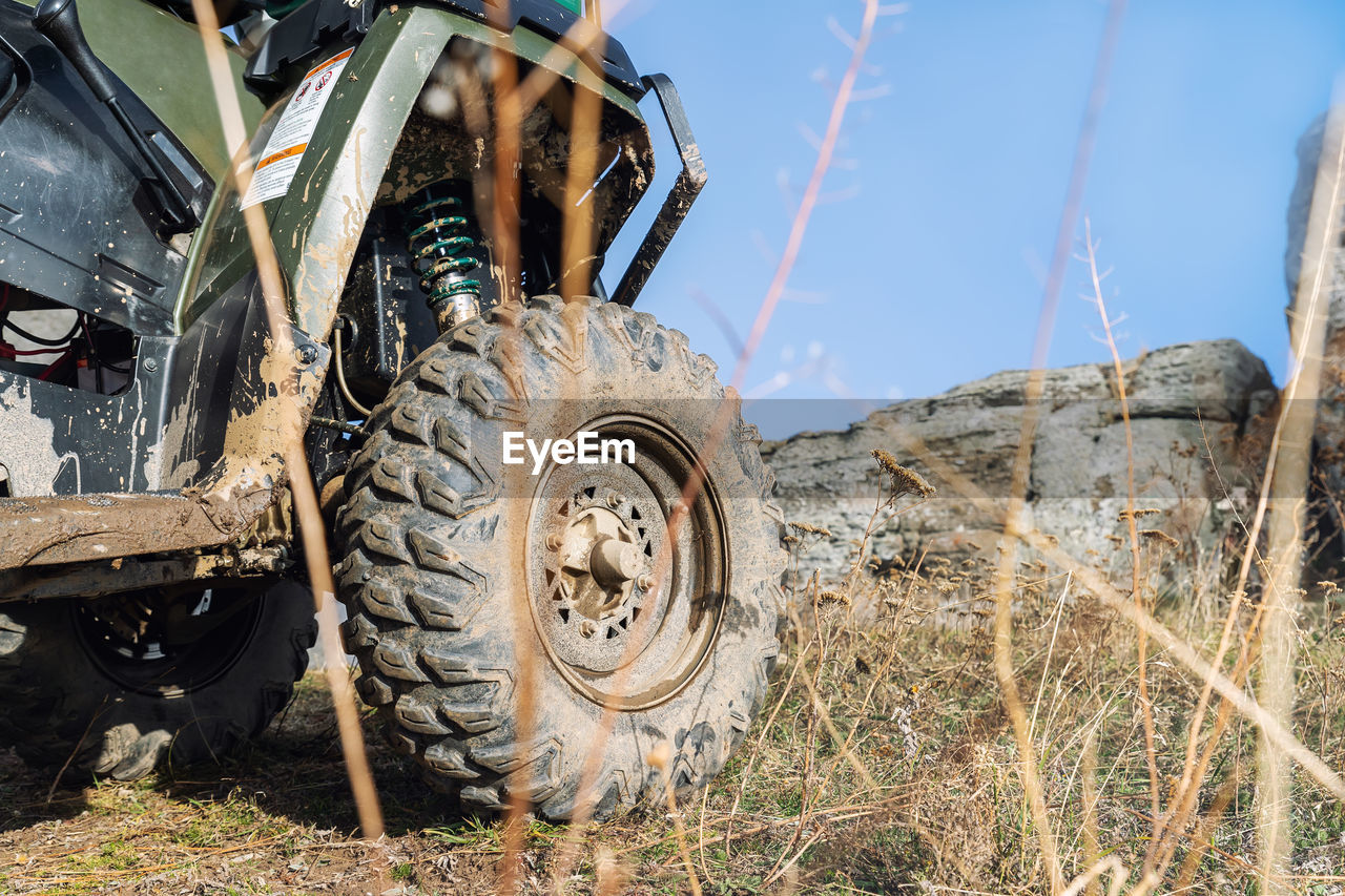 low angle view of abandoned vehicle on field against sky