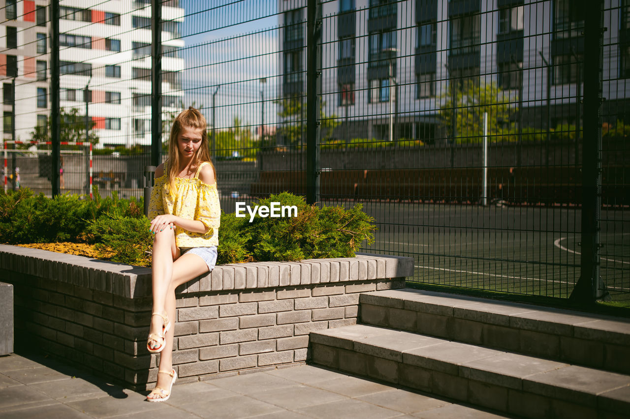 Portrait of young woman sitting outdoors