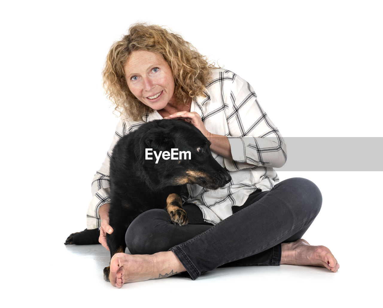 PORTRAIT OF WOMAN WITH DOG AGAINST GRAY BACKGROUND