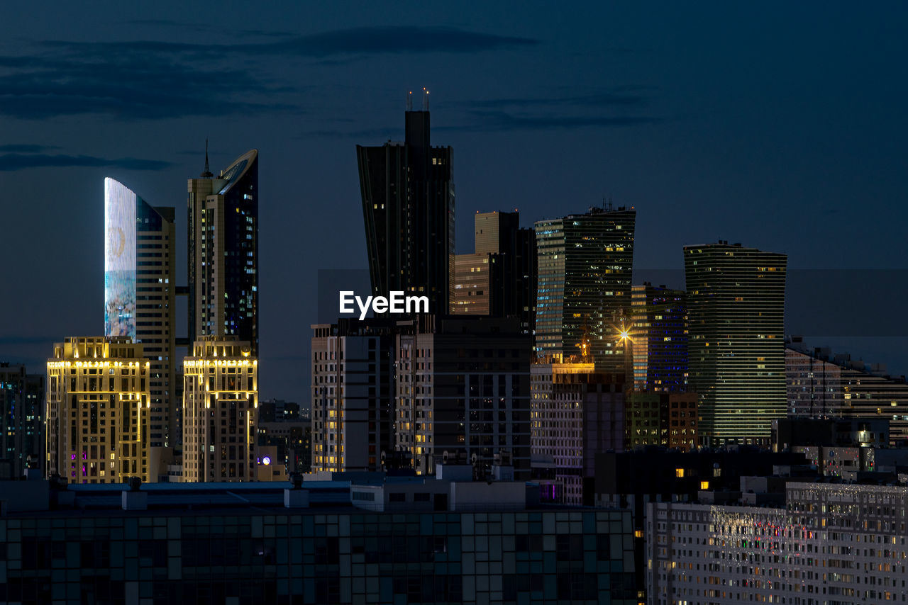 Illuminated buildings in city at night