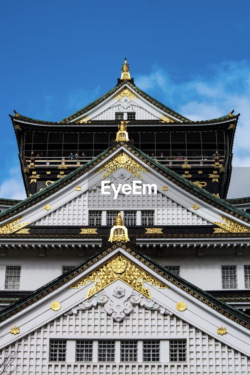 Low angle view of japanese castle building against sky