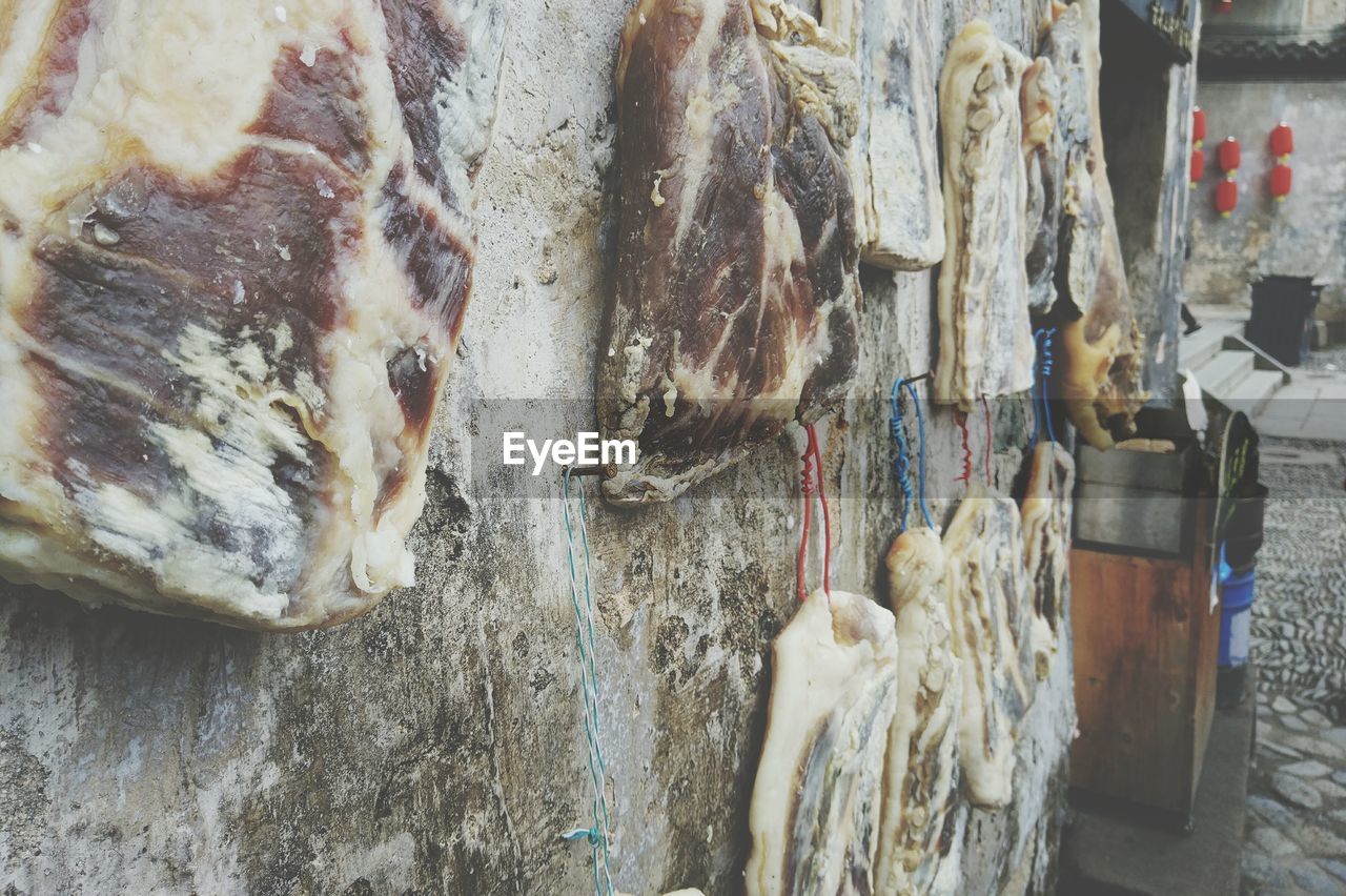 Meats hanging on wall for sale