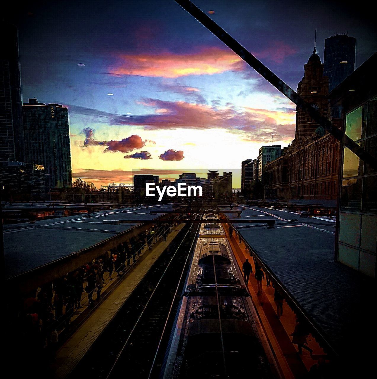 High angle view of train and silhouette people at railroad station