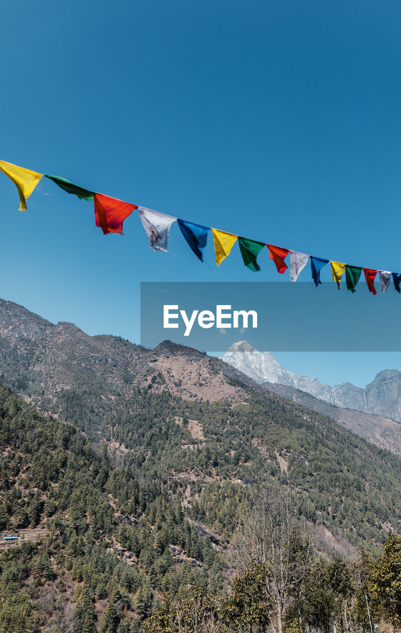 Prayer flags against blue sky, himalaya, nepal