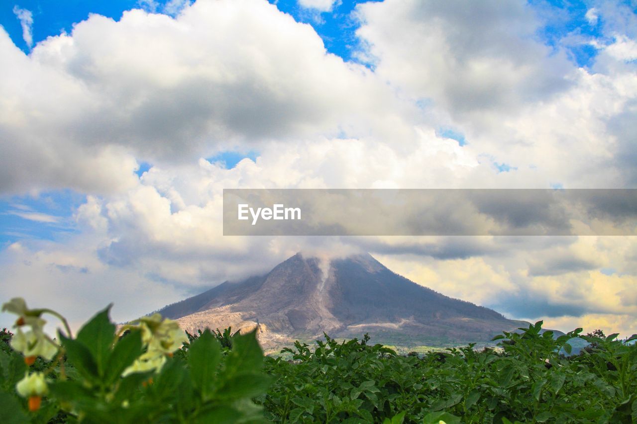 Scenic view of mount sinabung against cloudy sky