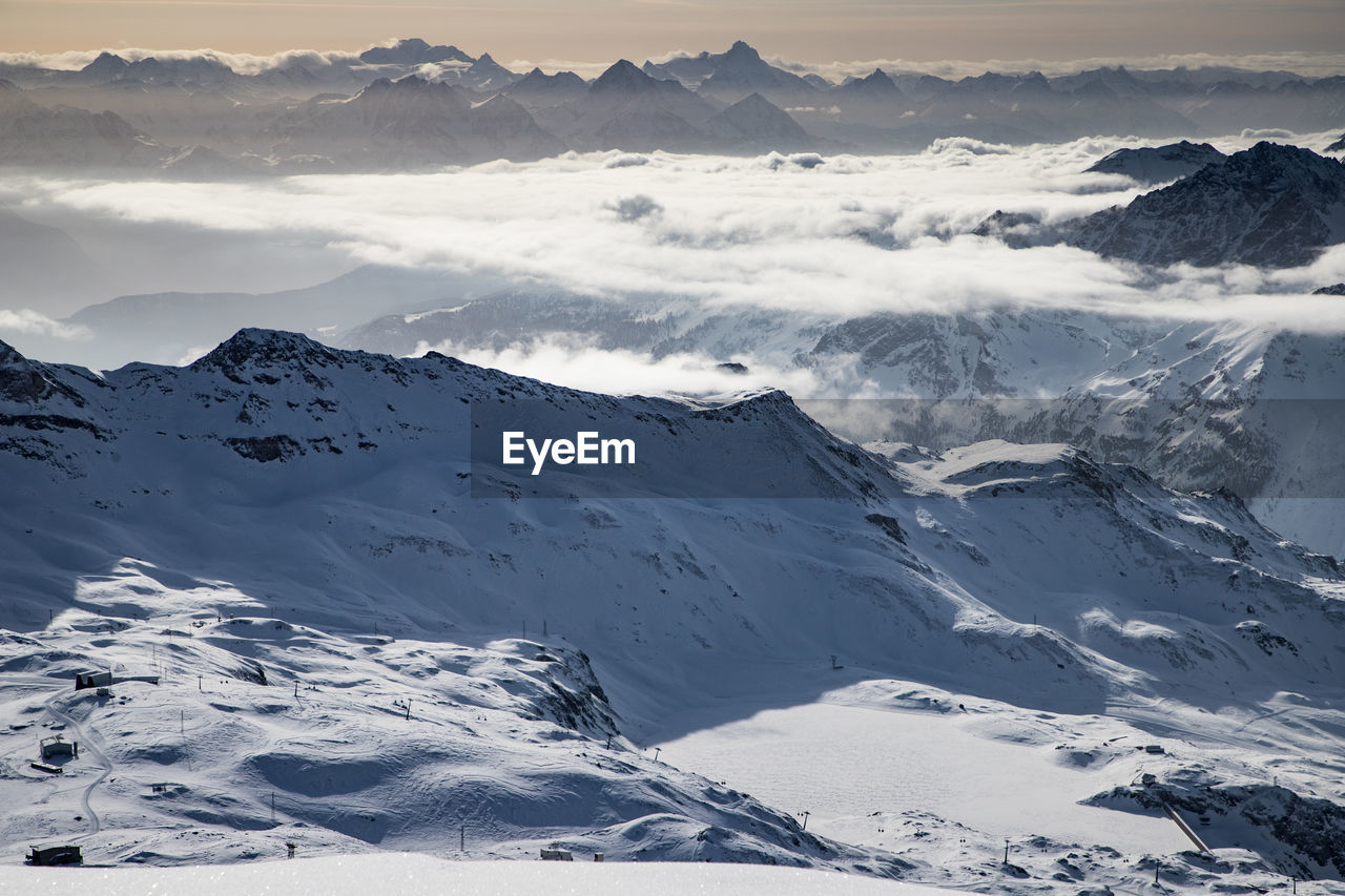 High angle view of snowcapped mountains against sky