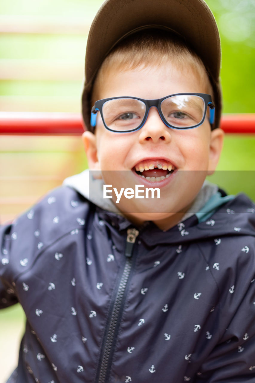 Funny little boy. funny boy with glasses laughs carefree. he's in a good mood. 