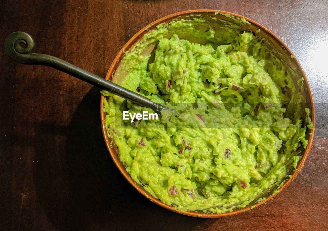High angle view of freshly made homemade guacamole in bowl