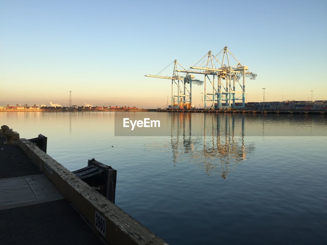 Pier on sea against clear sky during sunset