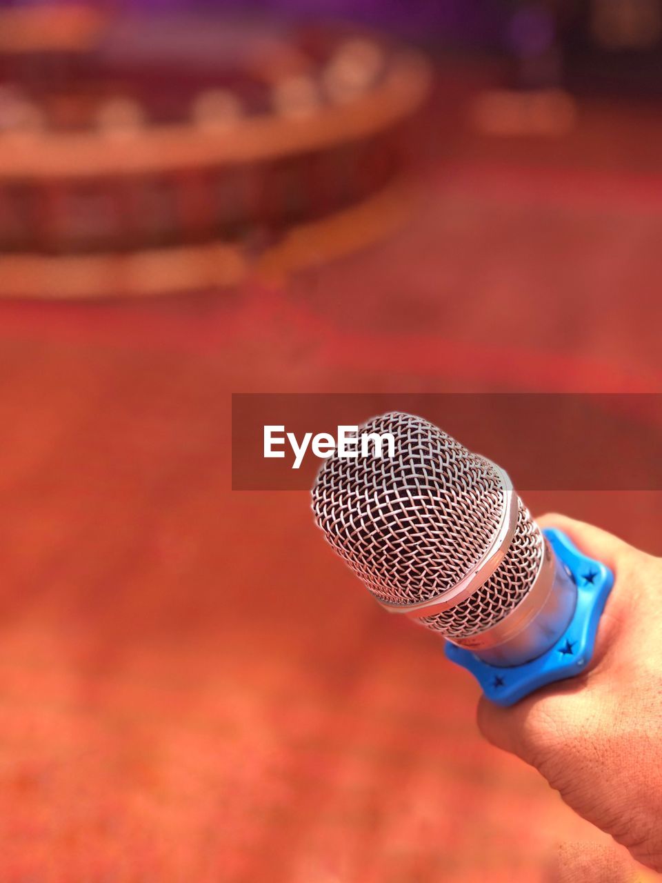 Close-up of hand holding microphone