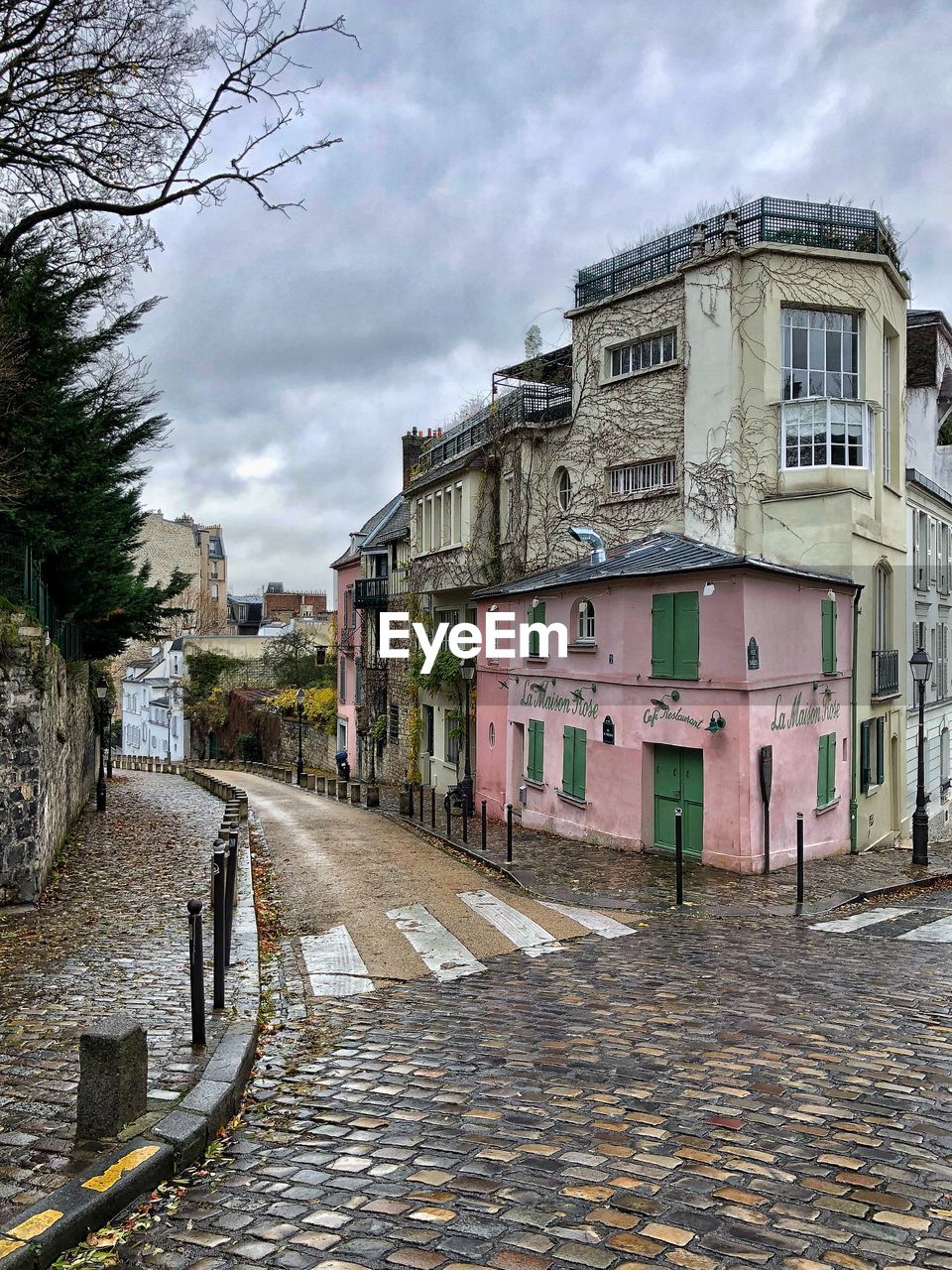 FOOTPATH BY BUILDINGS AGAINST SKY