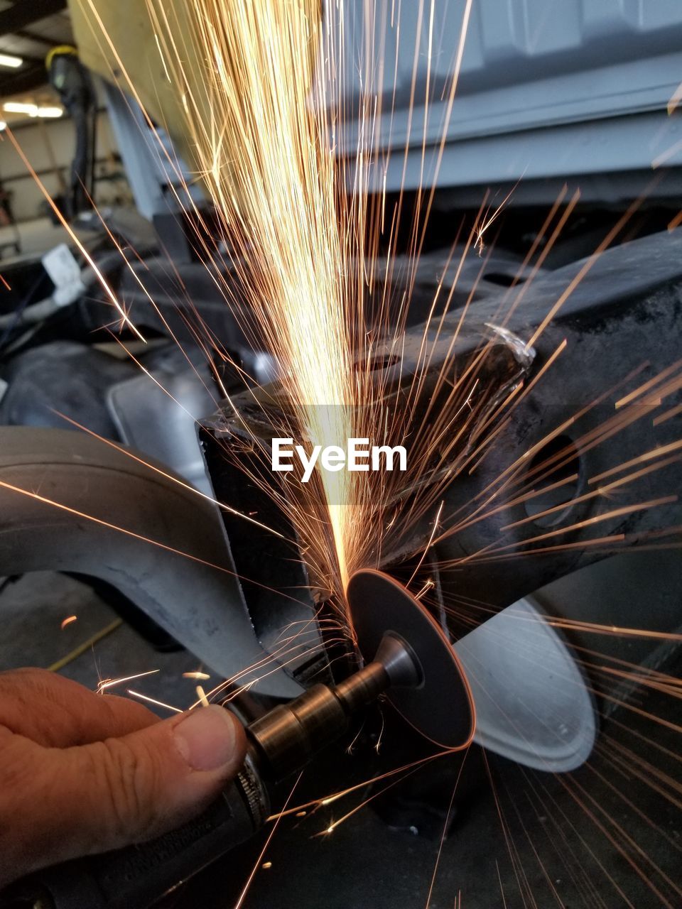 Close-up of hands working in factory