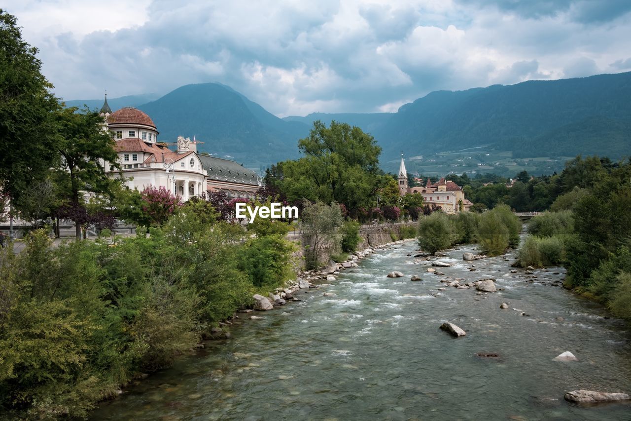 River amidst buildings against sky