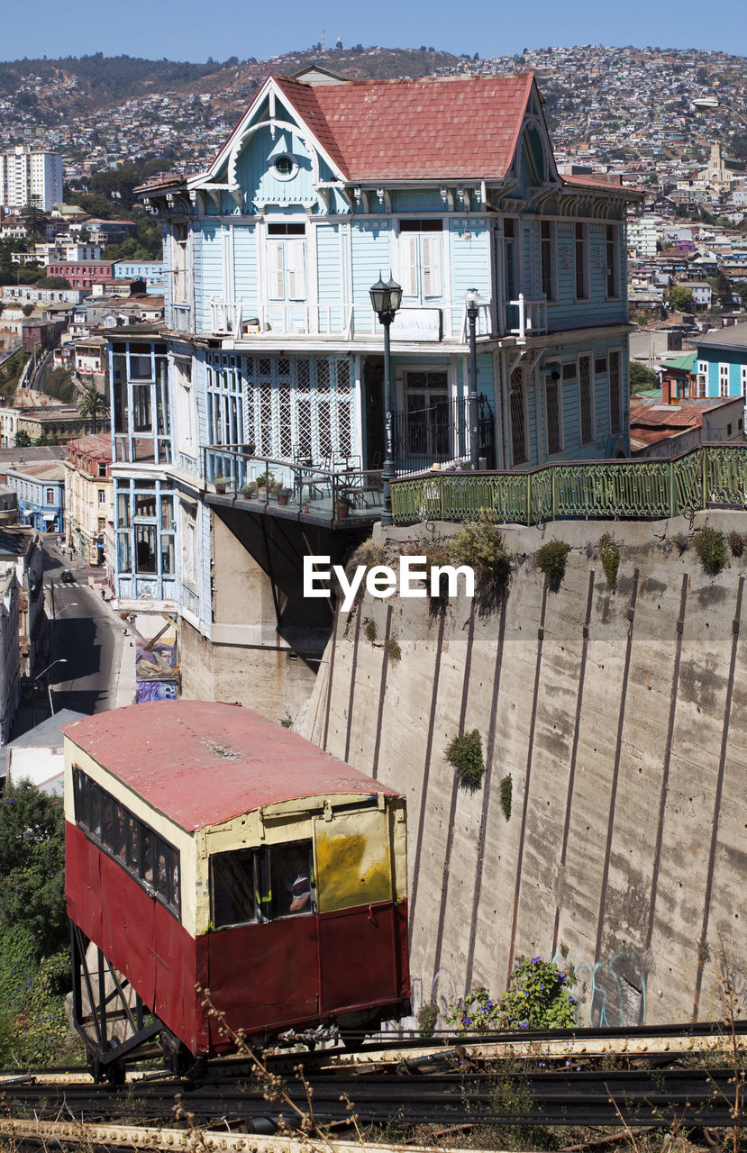 High angle view of house against buildings in city.  funicular railway in foreground.