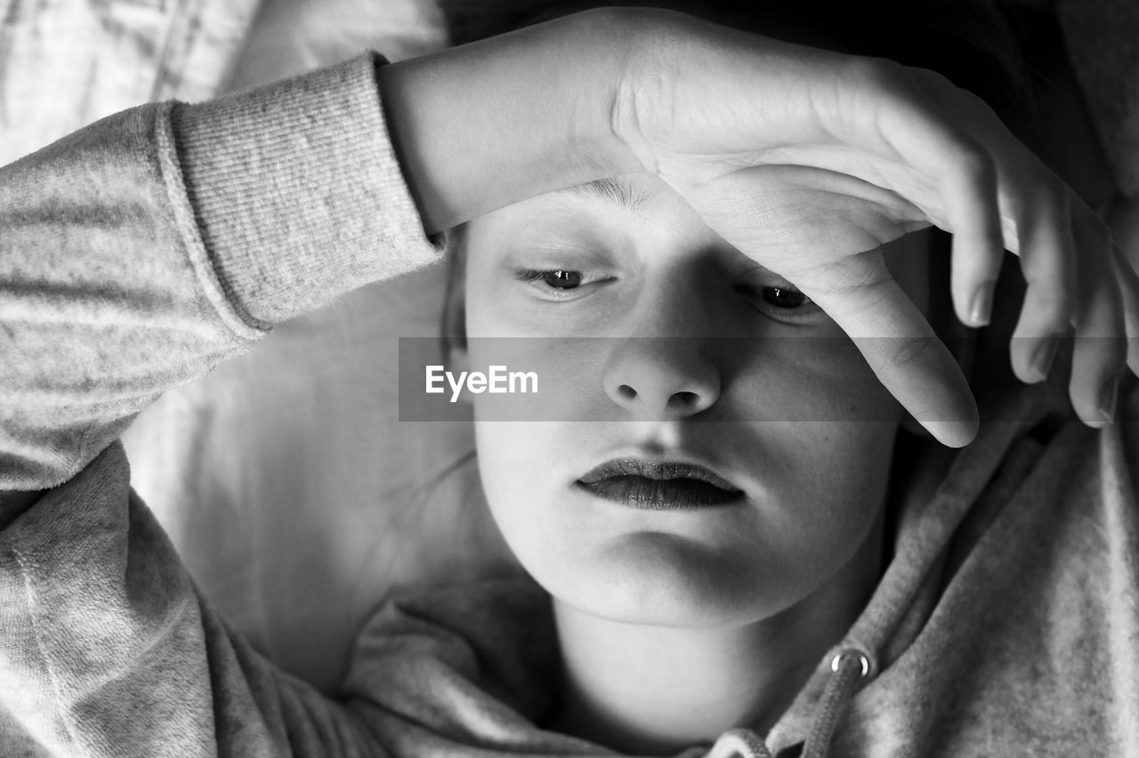 Close-up of teenage girl relaxing on bed