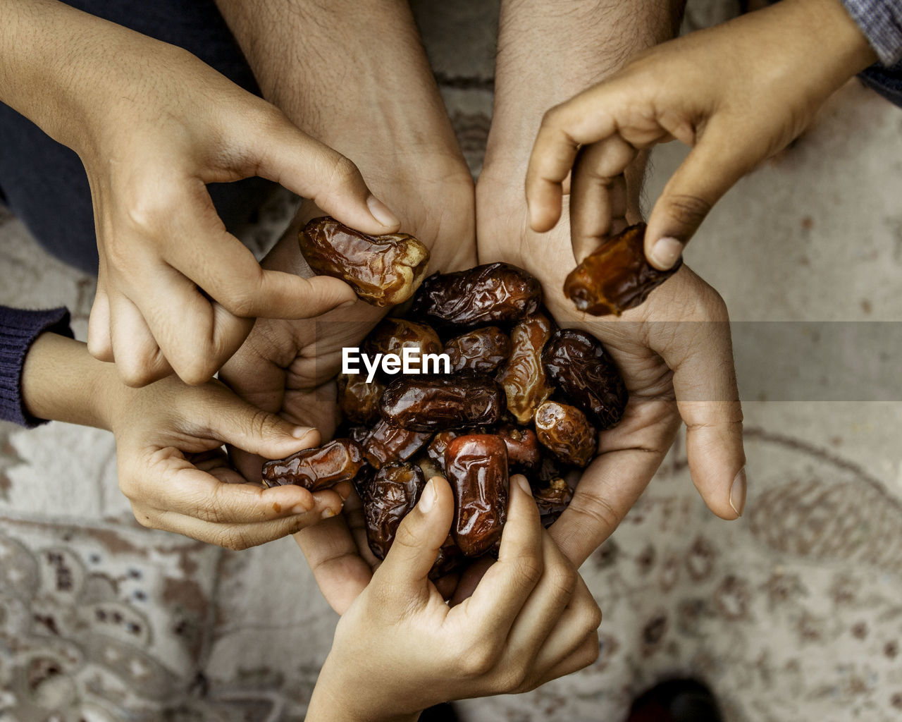 Cropped hands of people picking up dates