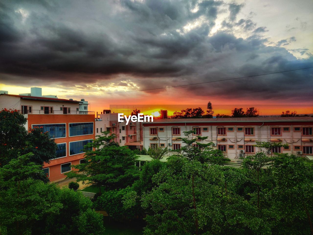 VIEW OF BUILDINGS AGAINST SKY DURING SUNSET