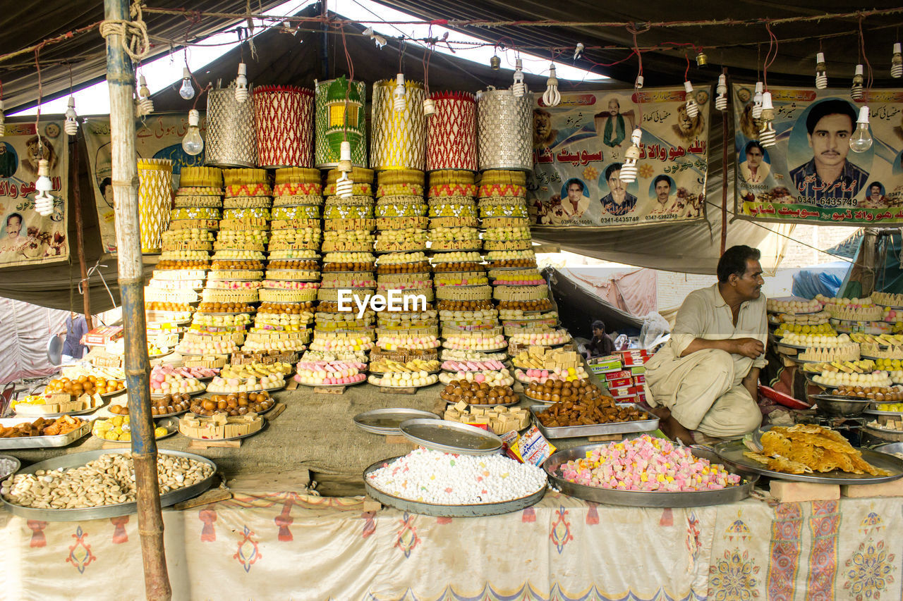 PEOPLE IN MARKET STALL