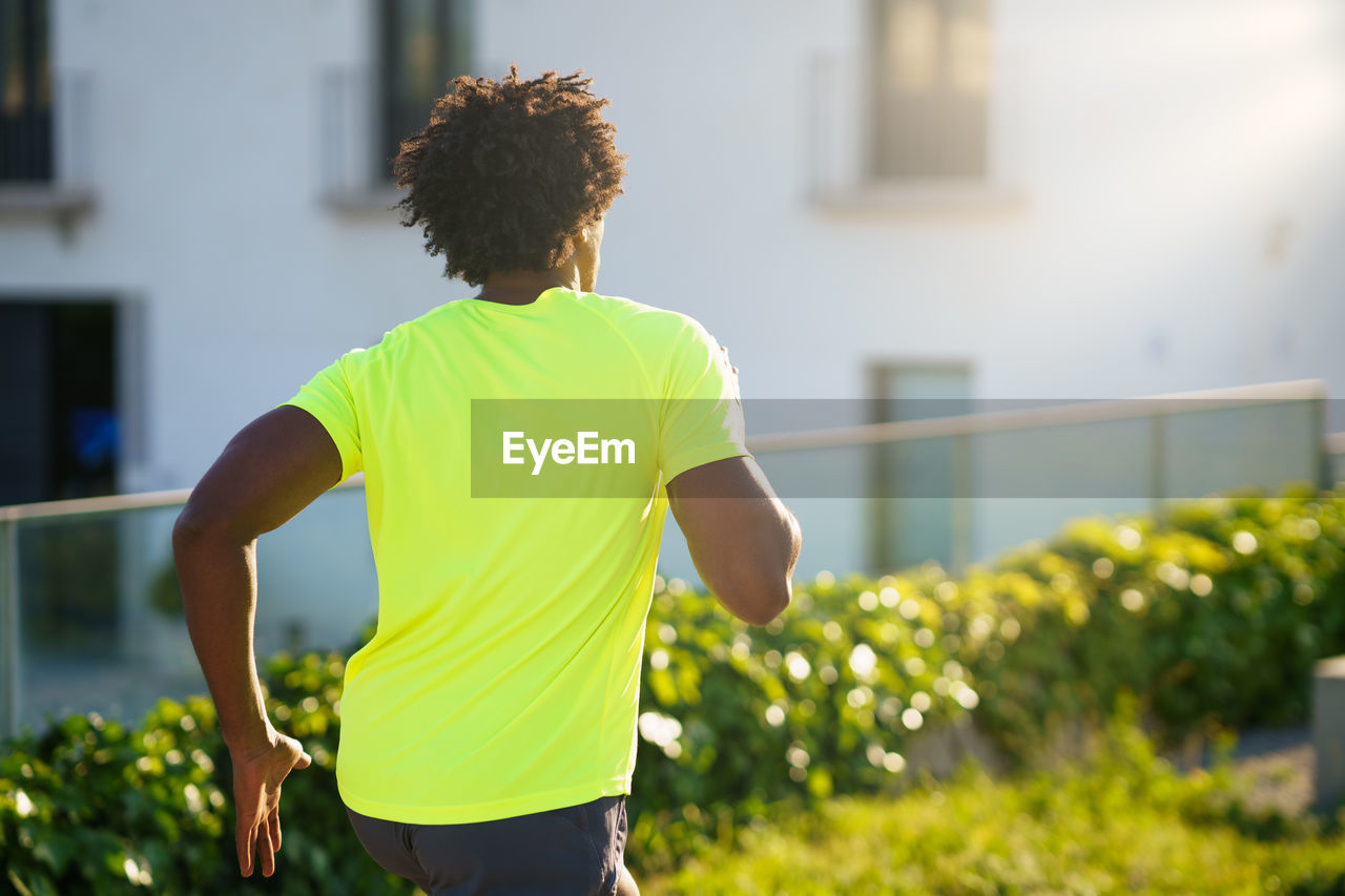 Rear view of man running outdoors