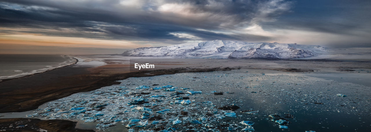 Scenic view of sea against sky during winter