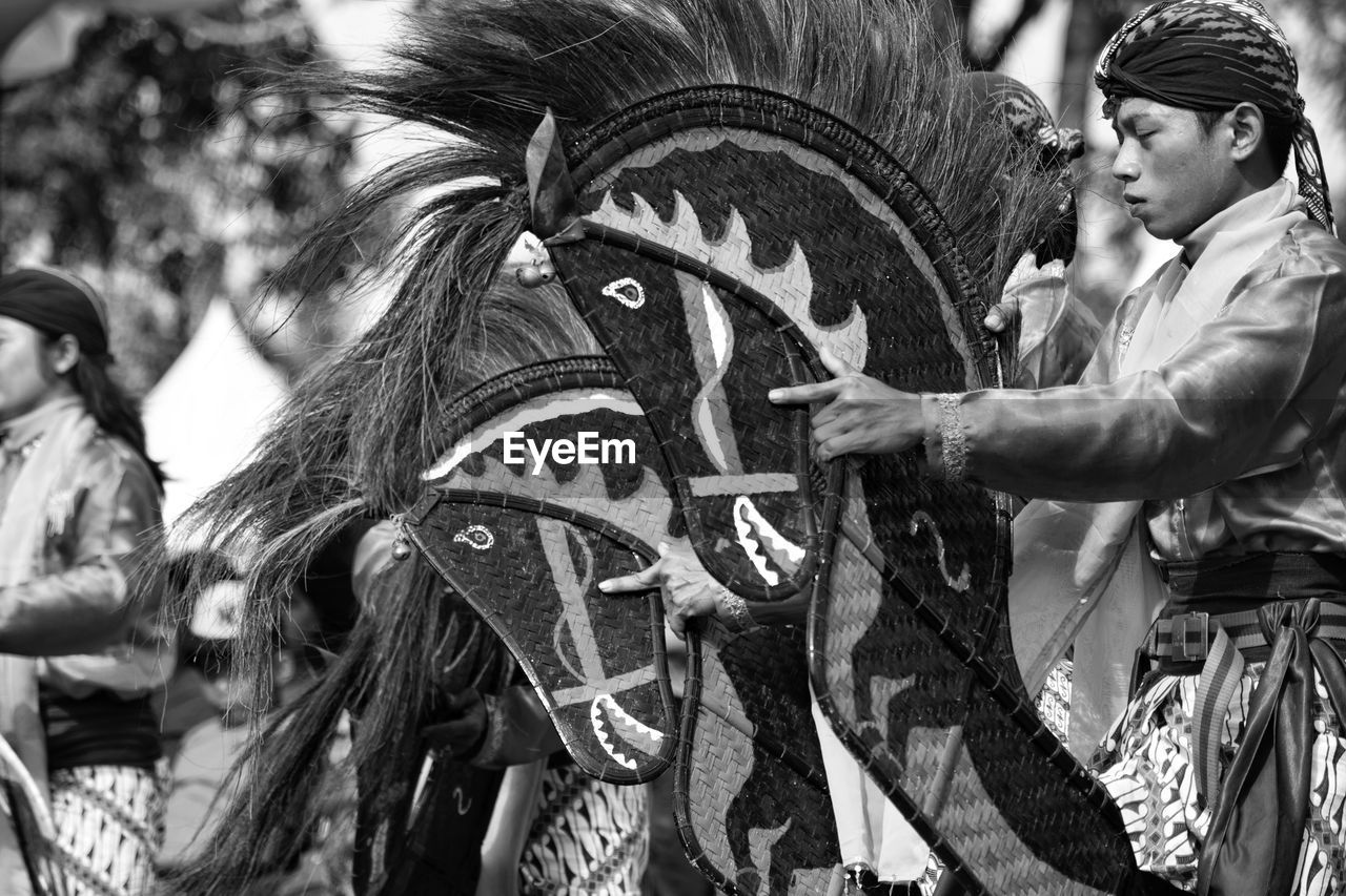 Side view of mid adult man with artificial horse