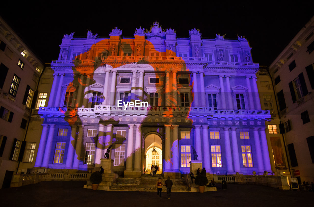 LOW ANGLE VIEW OF ILLUMINATED BUILDING