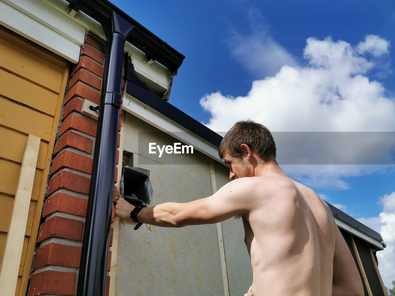 MAN STANDING AGAINST SKY