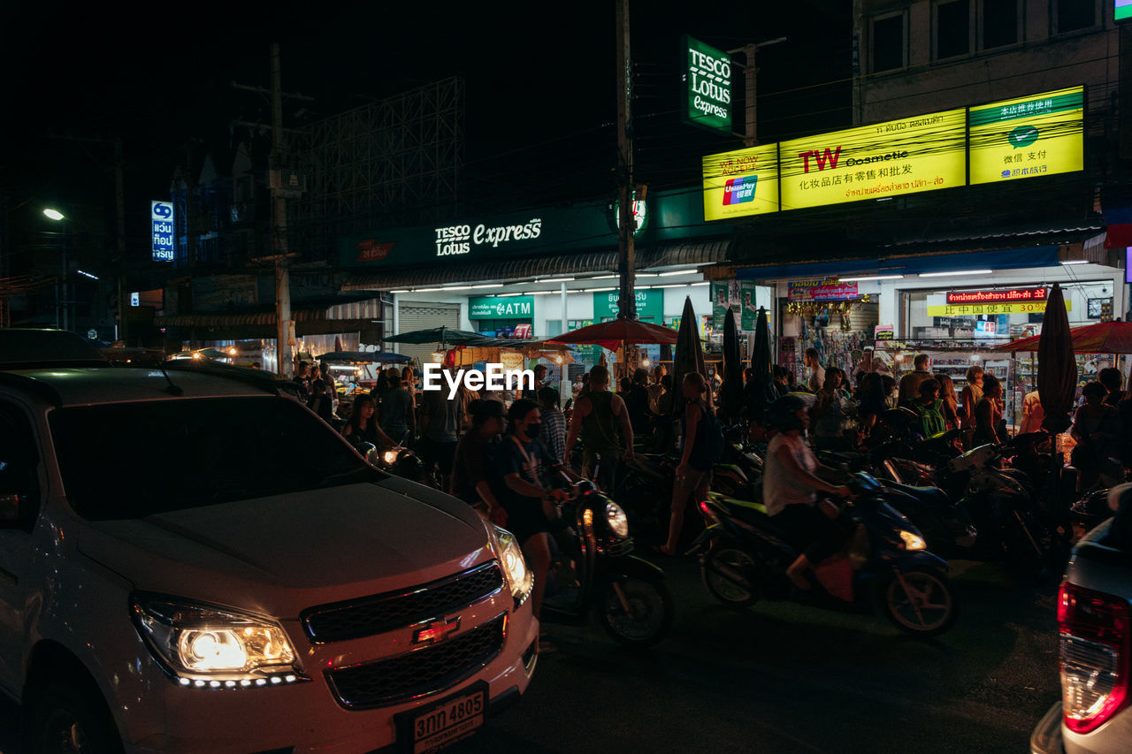 PEOPLE ON STREET AT NIGHT