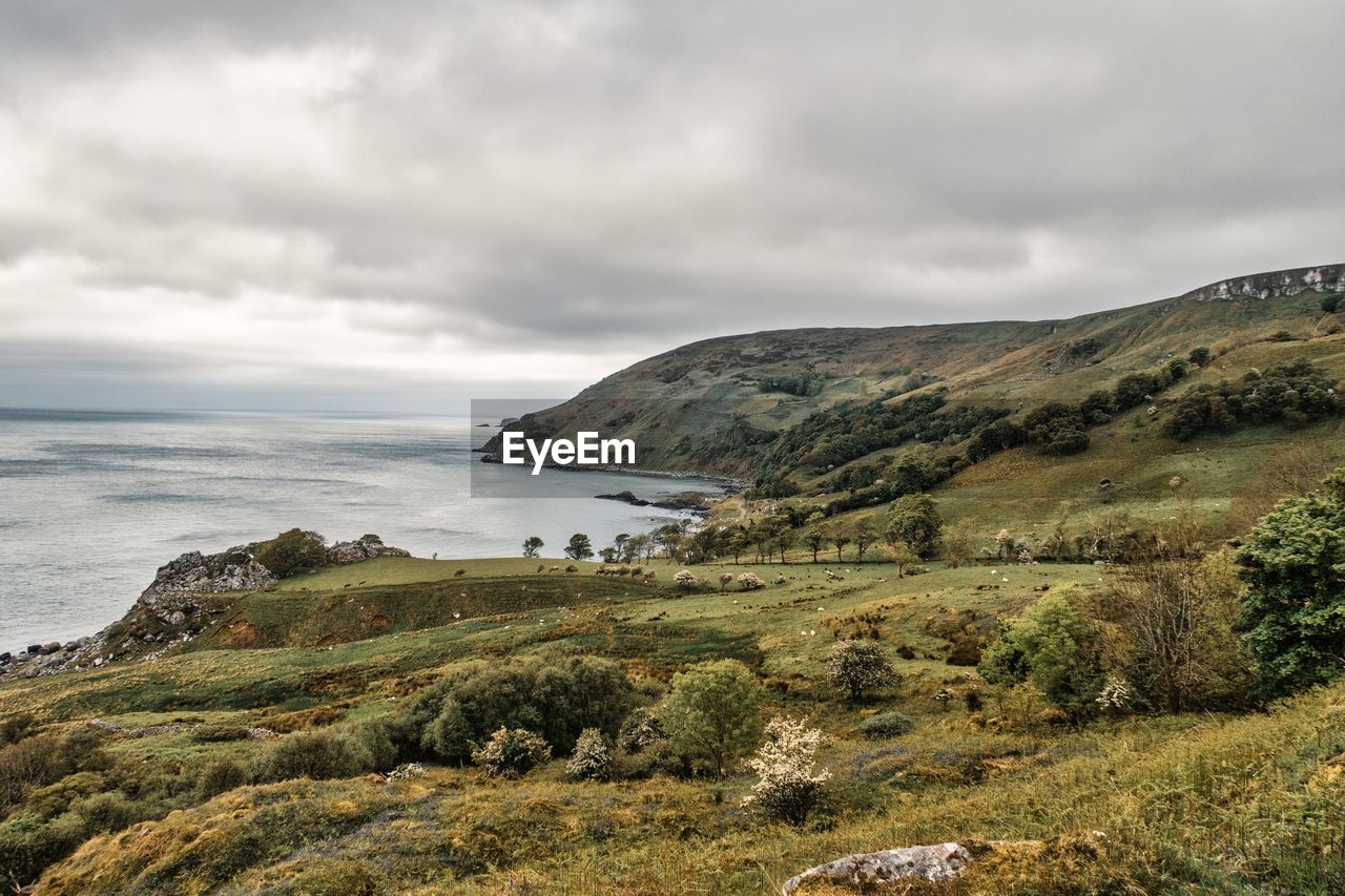 Scenic view of sea and mountains against sky