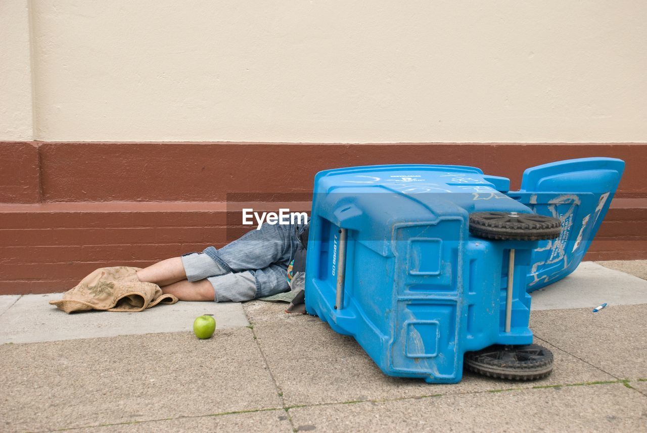 MAN LYING ON THE WALL OF A TABLE