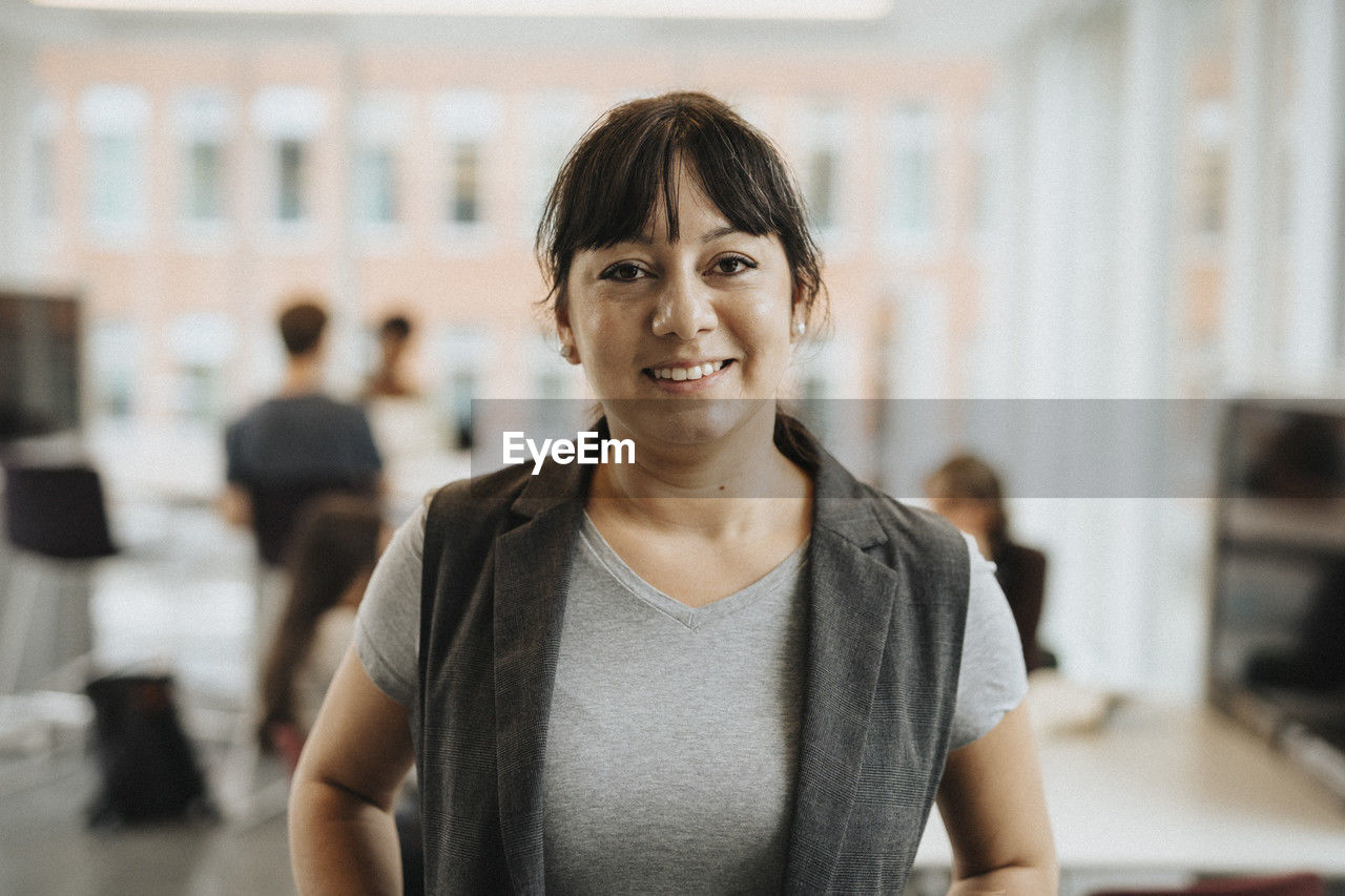 Portrait of smiling female professor in university