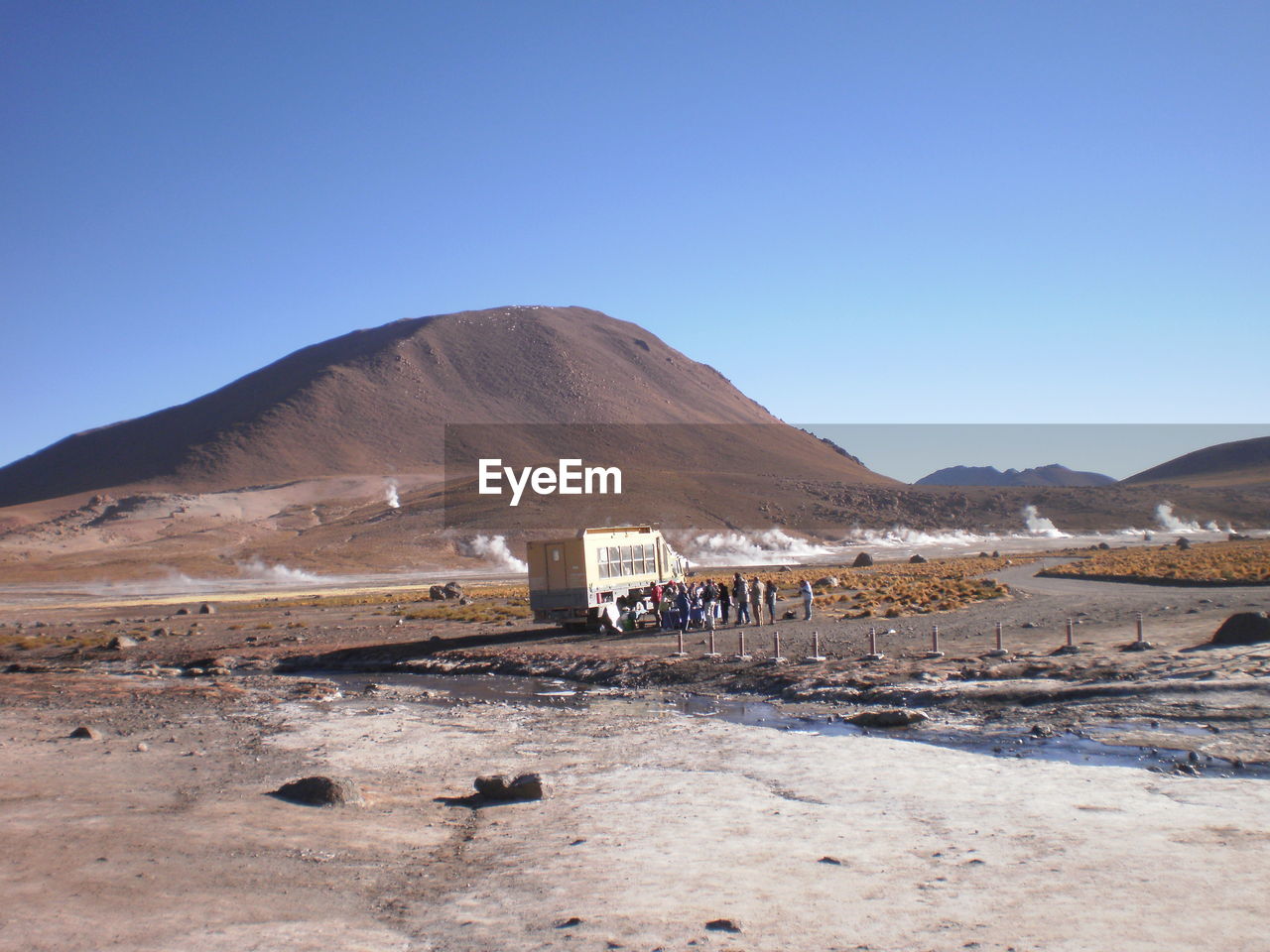 Stream and mountains against clear sky