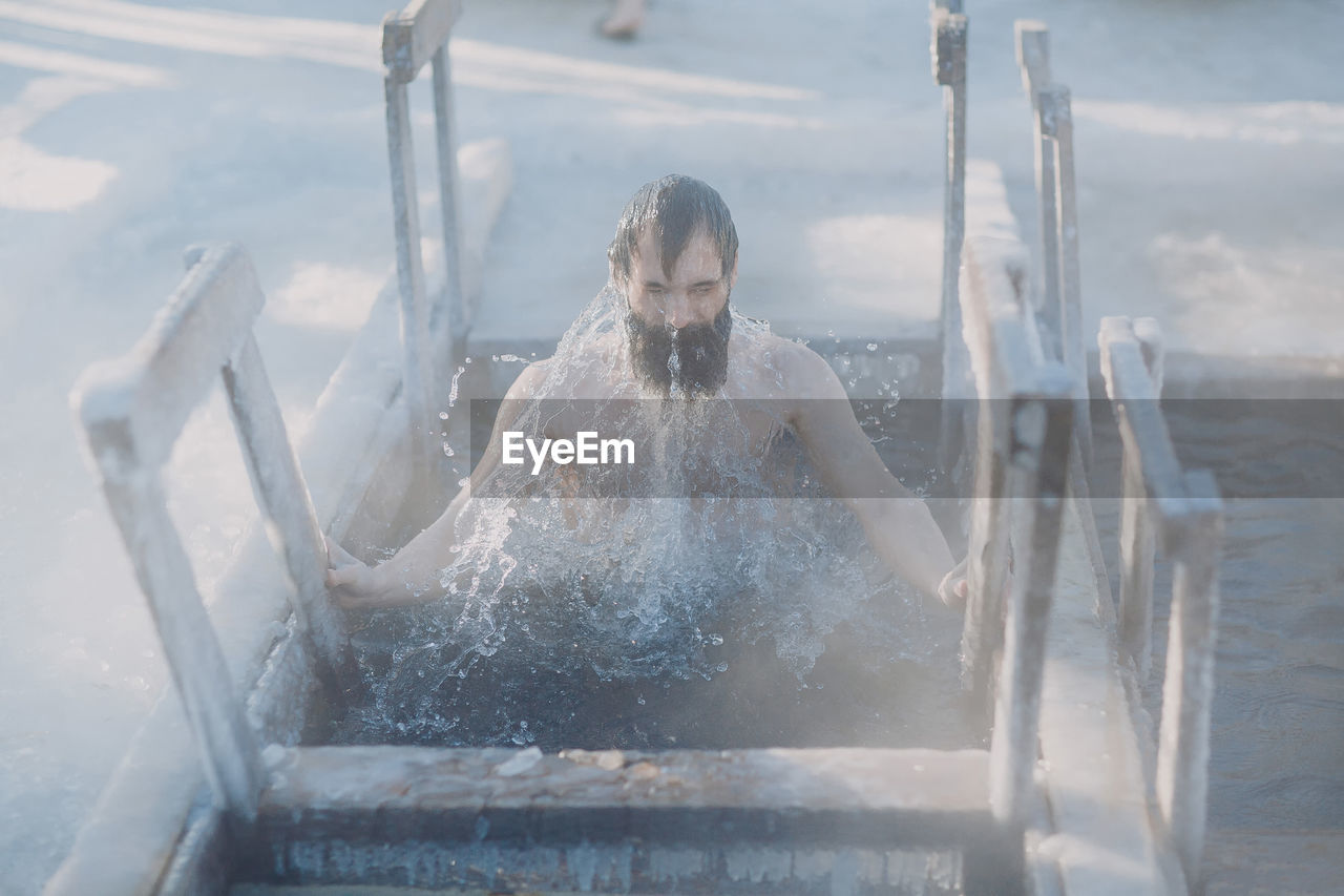 Man swimming during winter