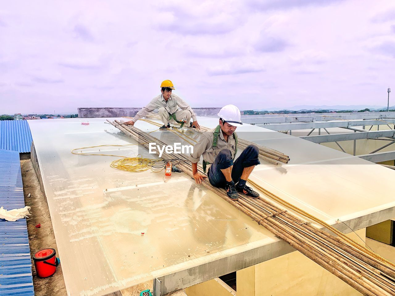 PEOPLE WORKING ON SEA AGAINST SKY